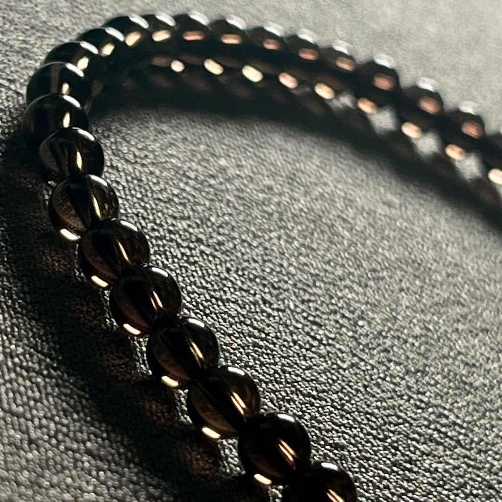 Smoky Quartz smooth round 4mm bead stretch bracelet (premium grade)