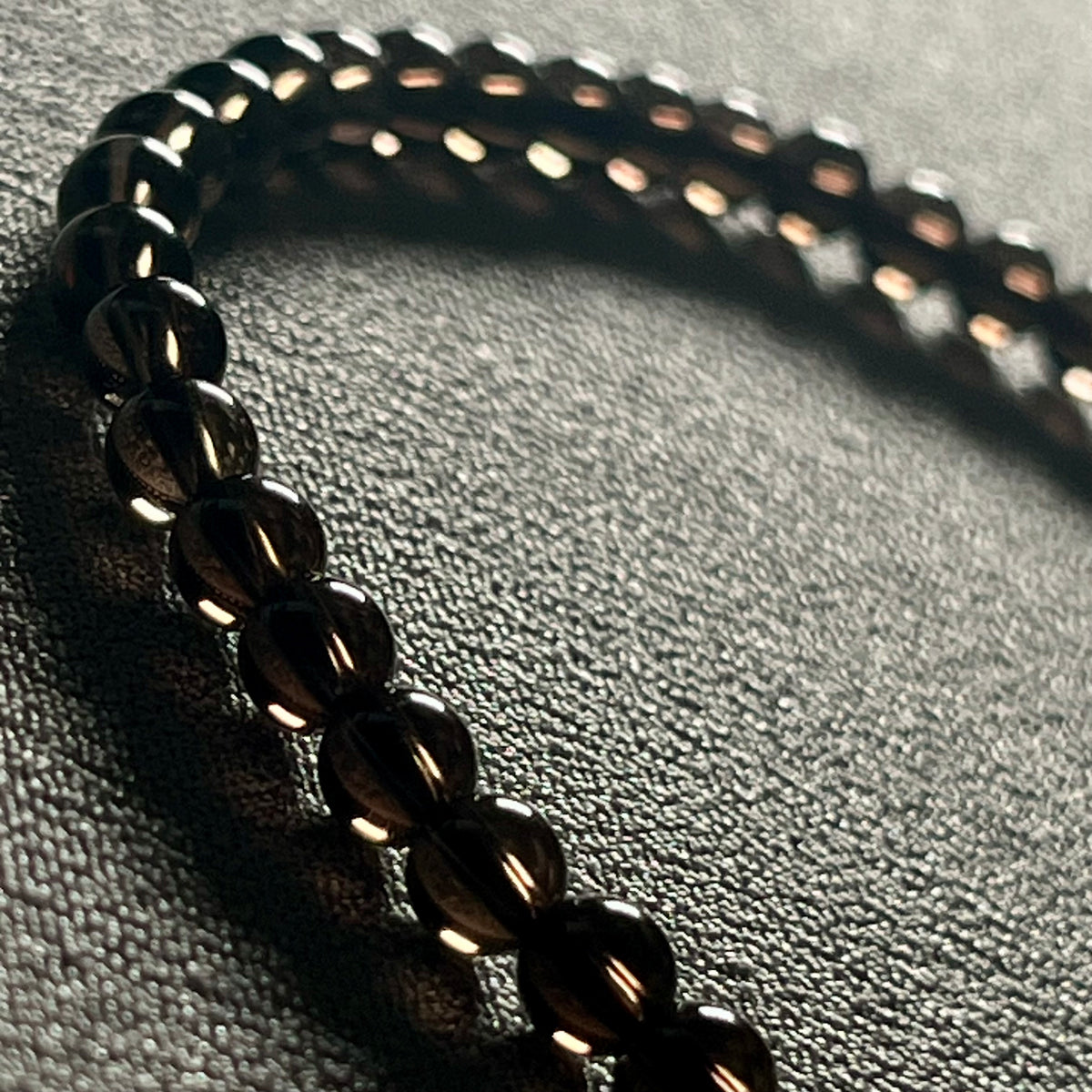 Smoky Quartz smooth round 4mm bead stretch bracelet (premium grade)