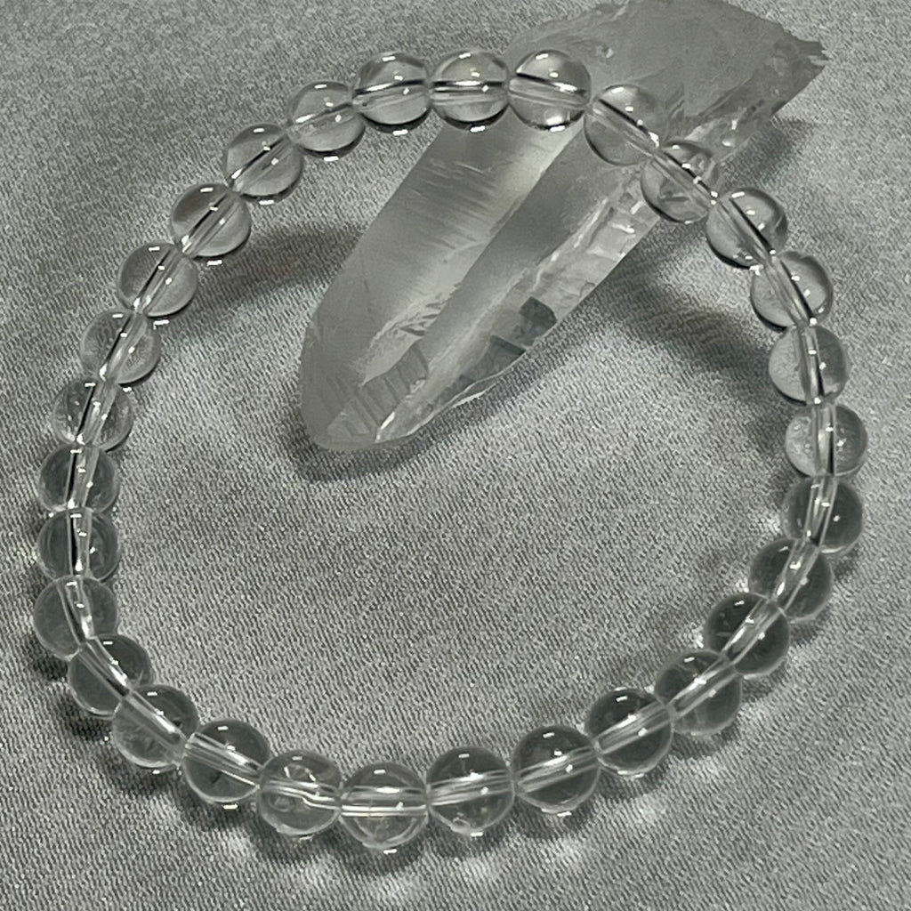 Clear Crystal Quartz smooth round 4mm, 6mm bead stretch bracelet (premium); April birthstone