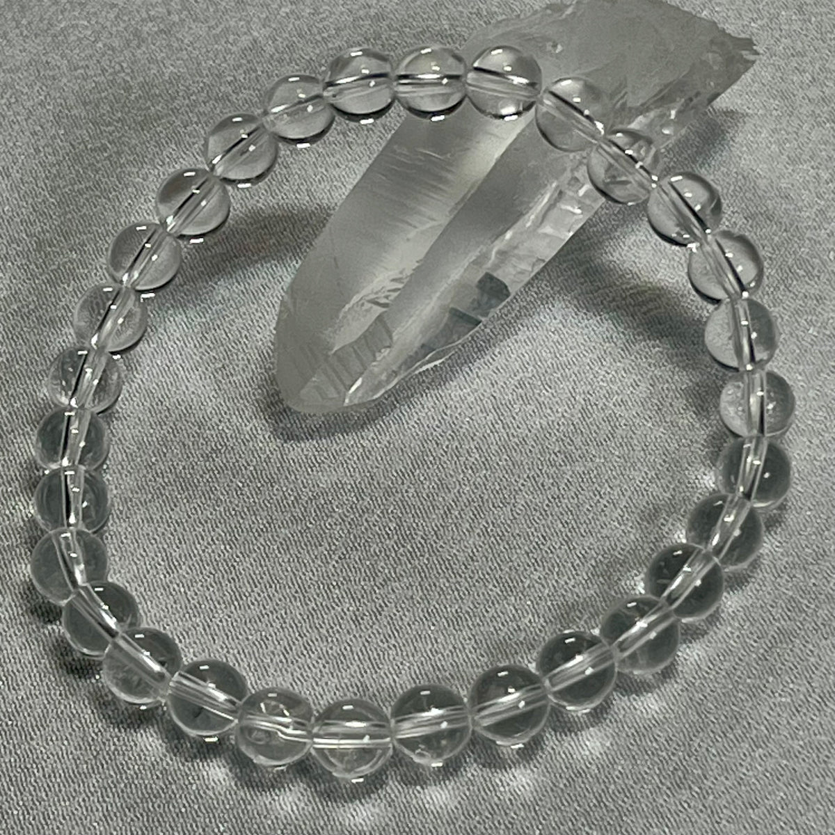 Clear Crystal Quartz smooth round 4mm, 6mm bead stretch bracelet (premium); April birthstone