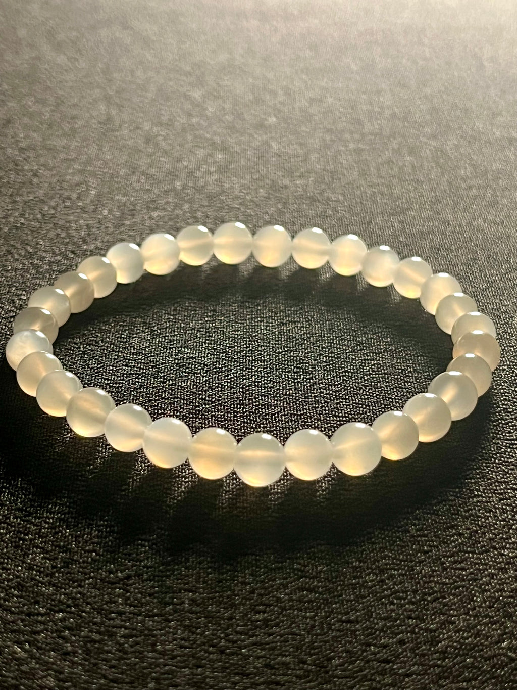 White Moonstone silver flash smooth round 6mm bead stretch bracelet (AA grade); alternative June birthstone