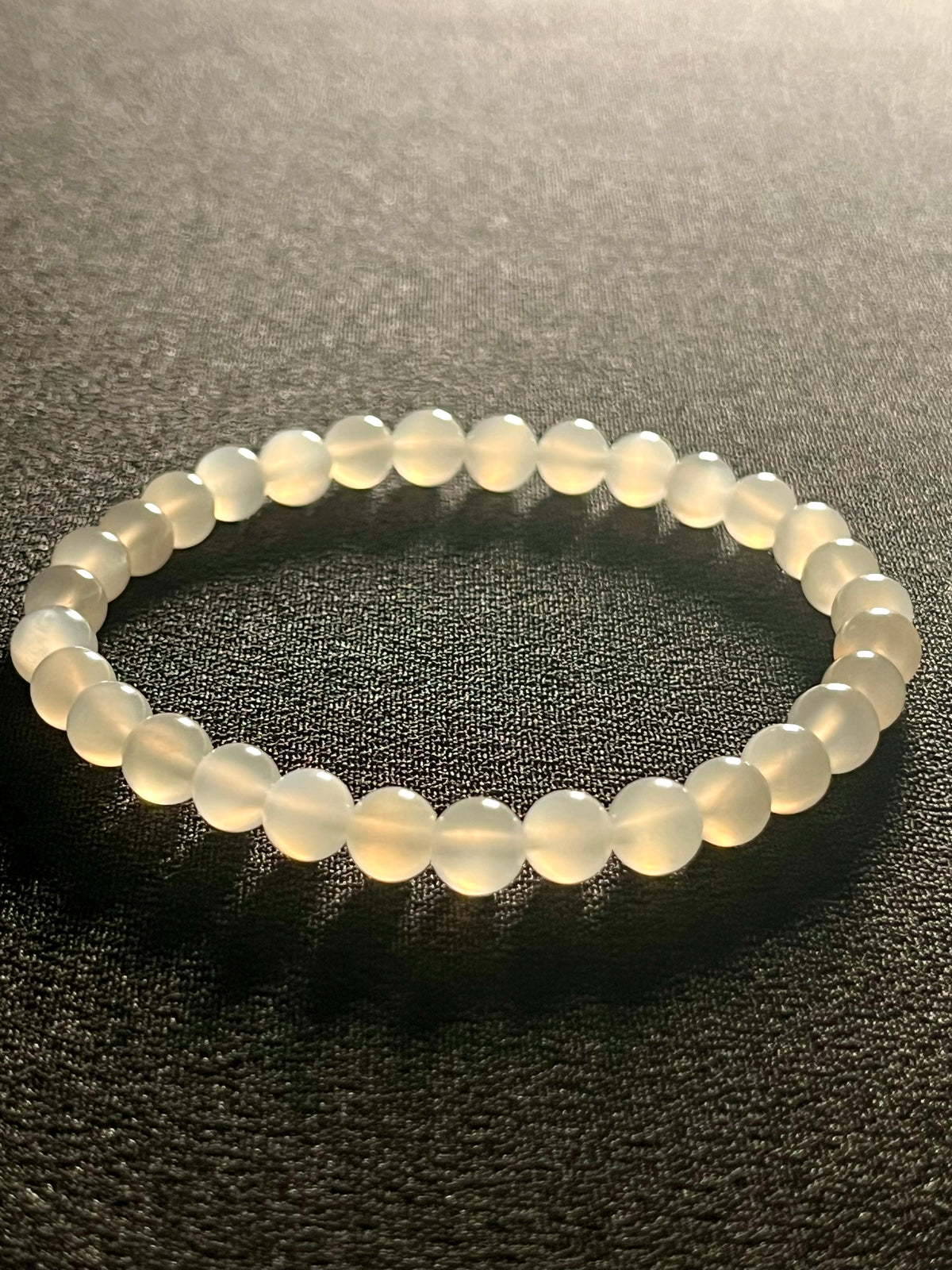 White Moonstone silver flash smooth round 6mm bead stretch bracelet (AA grade); alternative June birthstone