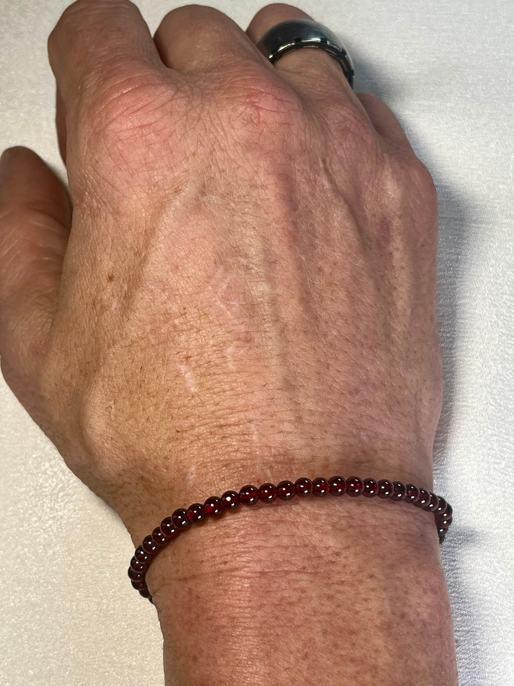 Red Garnet smooth round 4mm stretch bracelet (AA grade); January birthstone