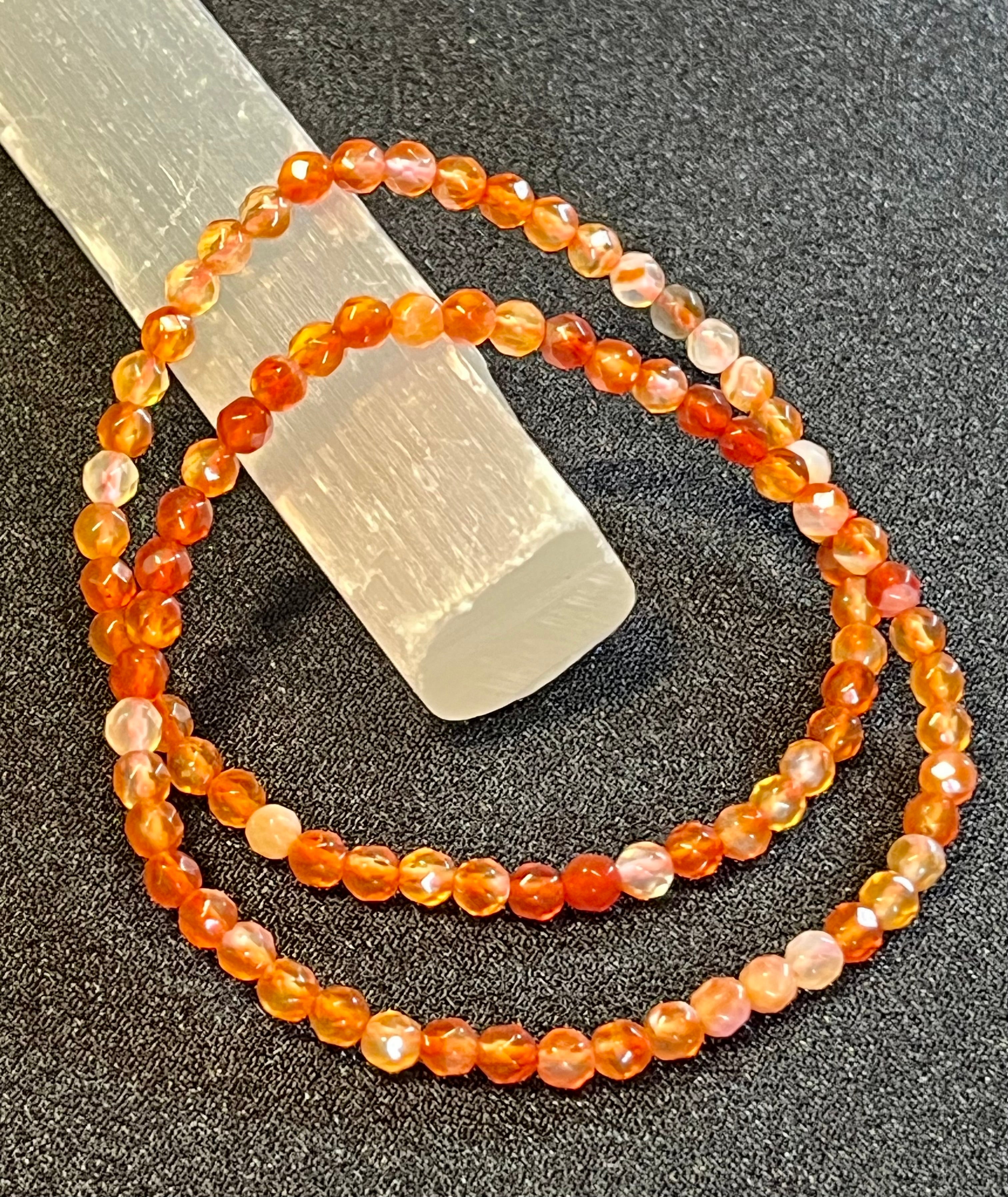 Carnelian (multi-orange) faceted round 4mm bead stretch bracelet; July birthstone