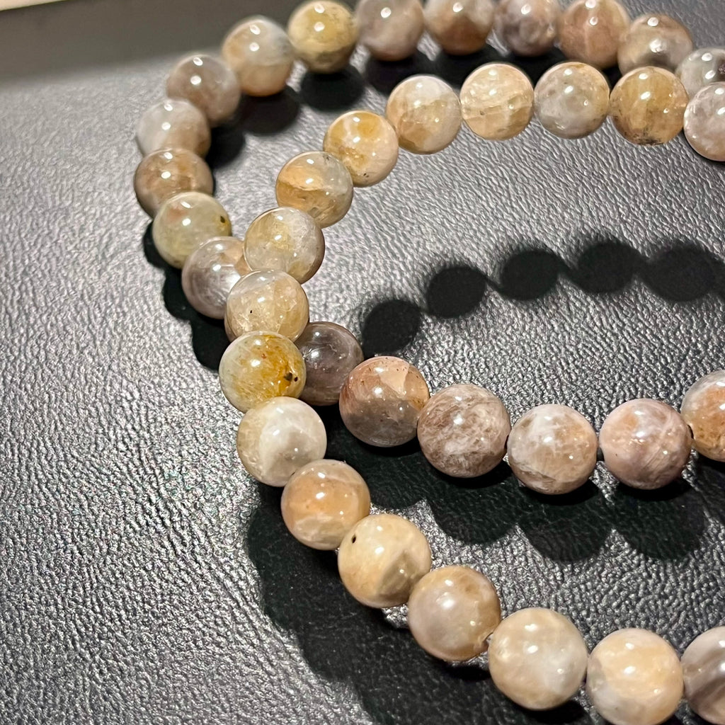 Black Sunstone smooth round 7mm bead stretch bracelet (AA grade)