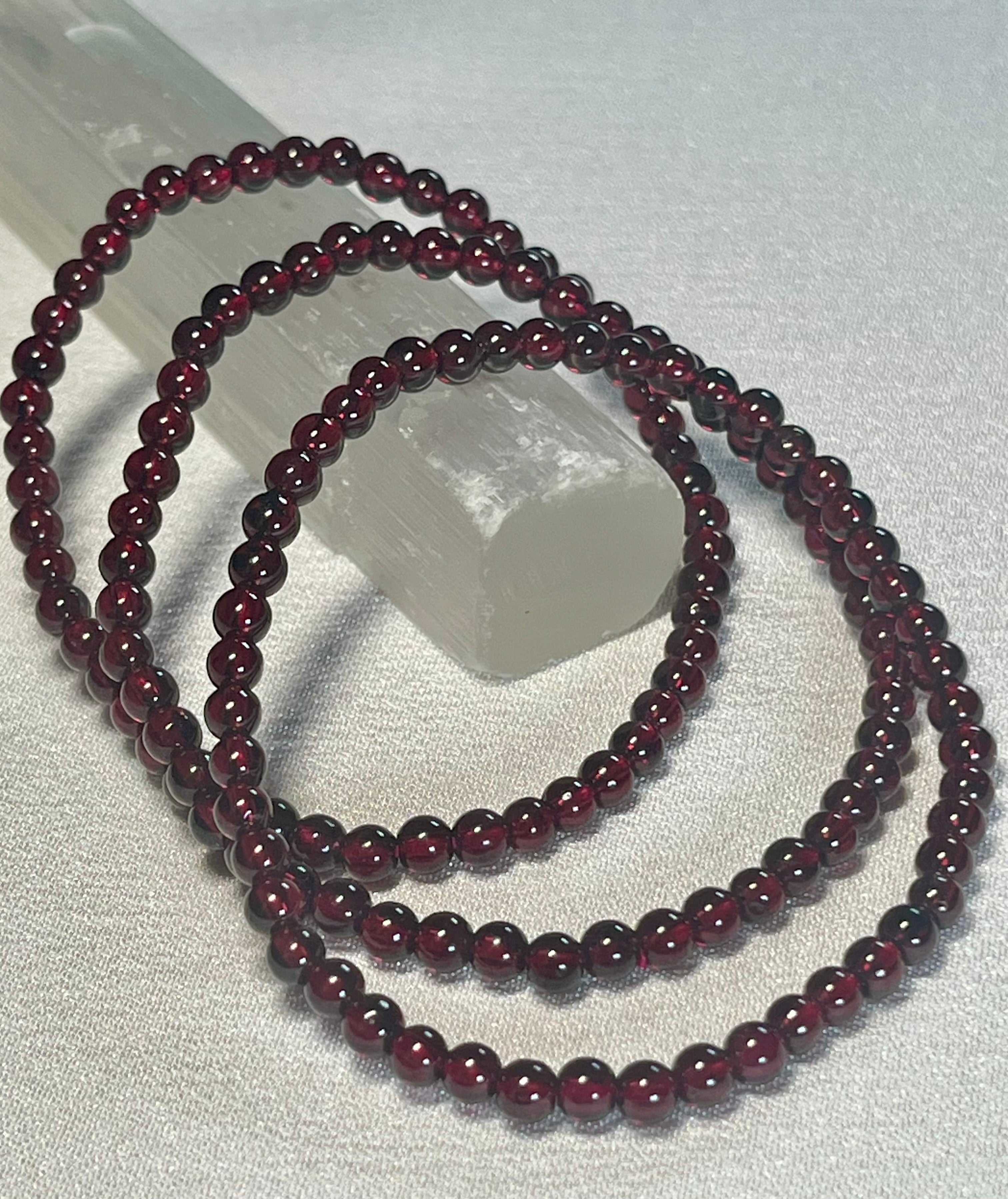 Red Garnet smooth round 4mm stretch bracelet (AA grade); January birthstone