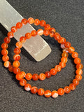 Carnelian (dark orange) smooth round 6mm bead stretch bracelet; July birthstone
