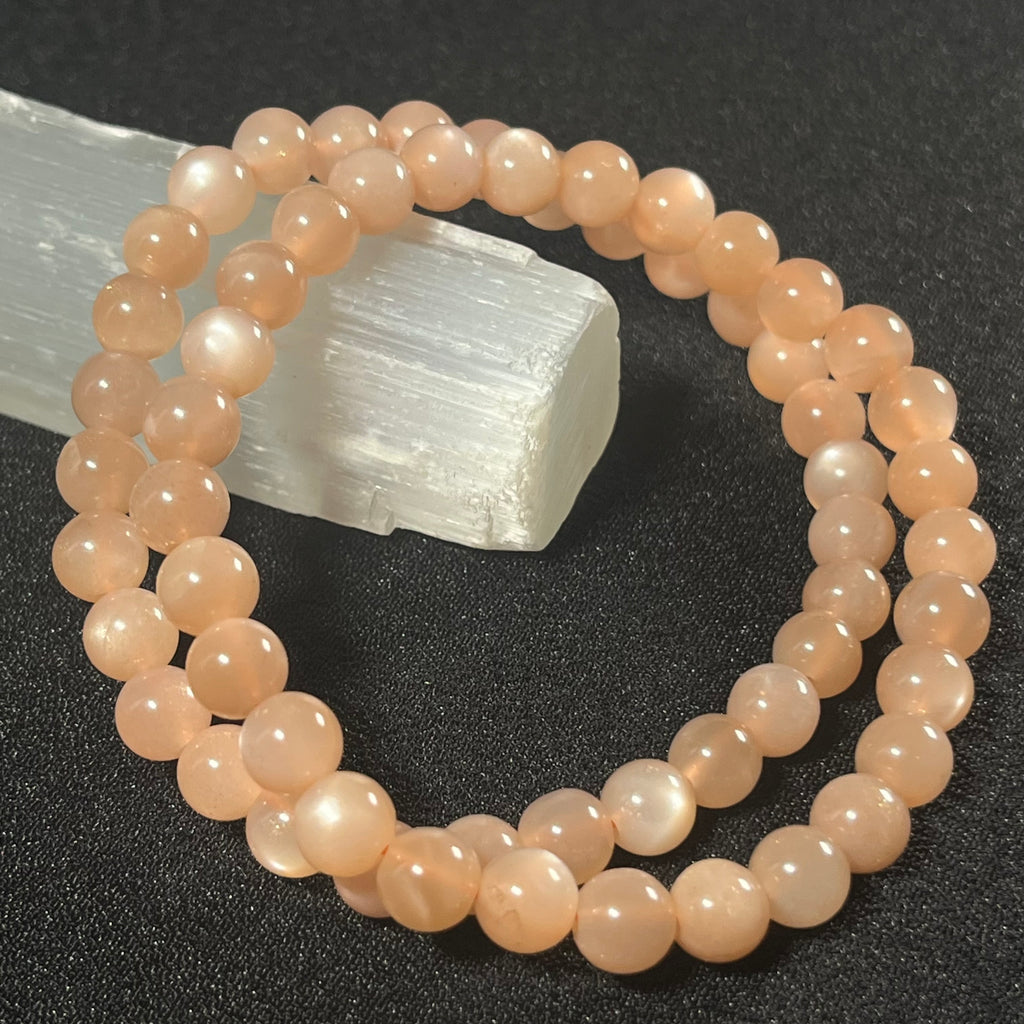 Peach Moonstone (w/ strong flash) smooth round 6mm bead stretch bracelet; June birthstone