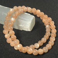 Peach Moonstone (w/ strong flash) smooth round 6mm bead stretch bracelet; June birthstone