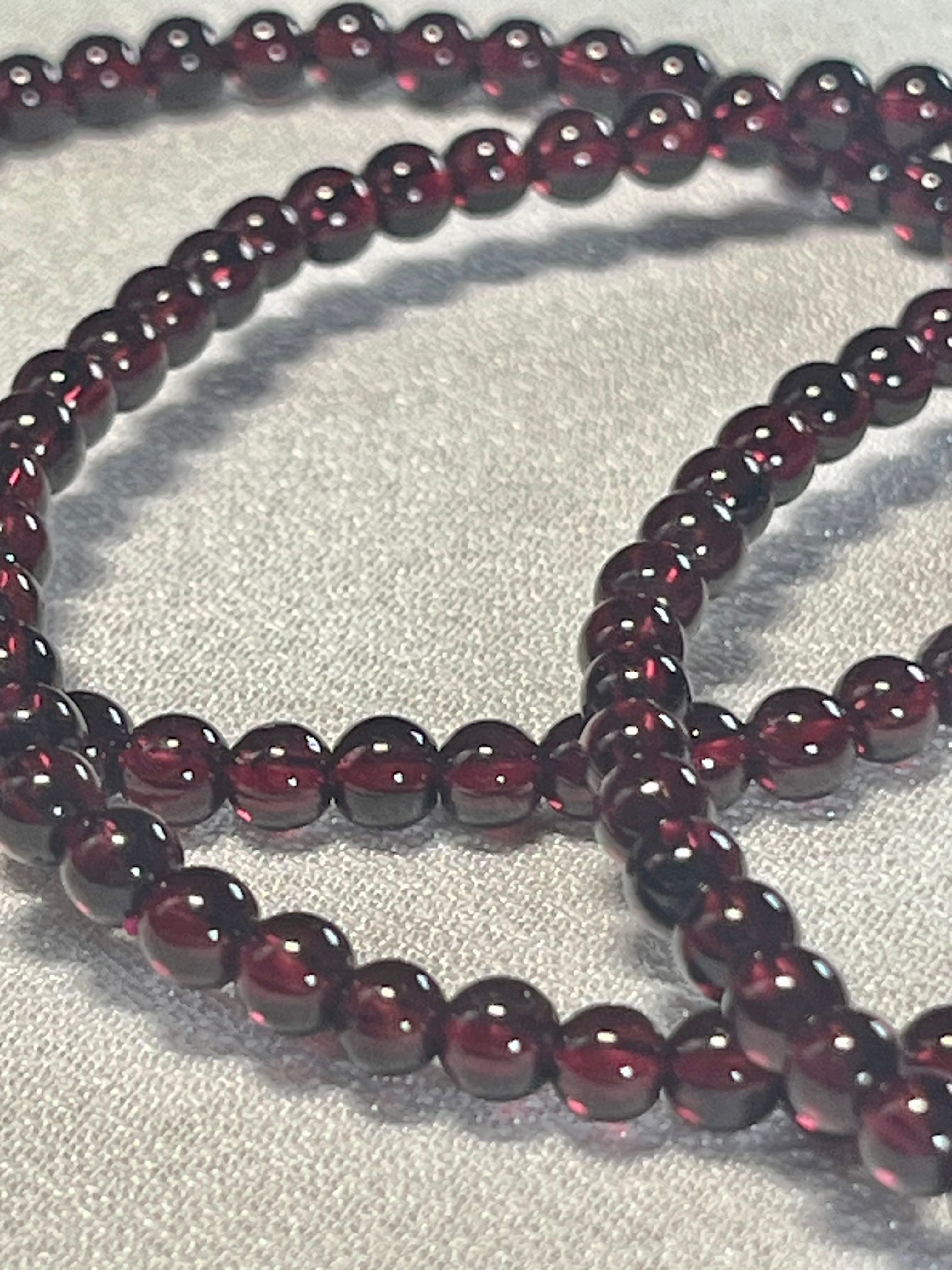 Red Garnet smooth round 4mm stretch bracelet (AA grade); January birthstone