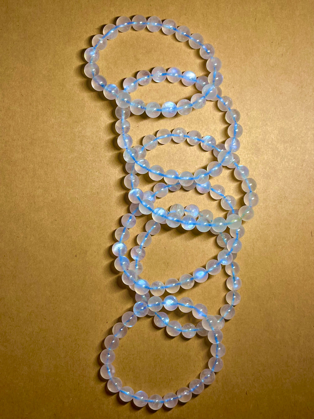 Blue Moonstone smooth round 8mm high-clarity blue flash bead stretch bracelet; June birthstone