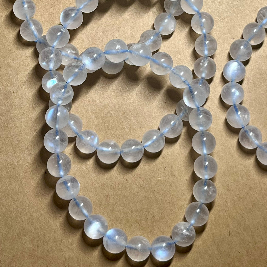 Blue Moonstone smooth round 8mm high-clarity blue flash bead stretch bracelet; June birthstone