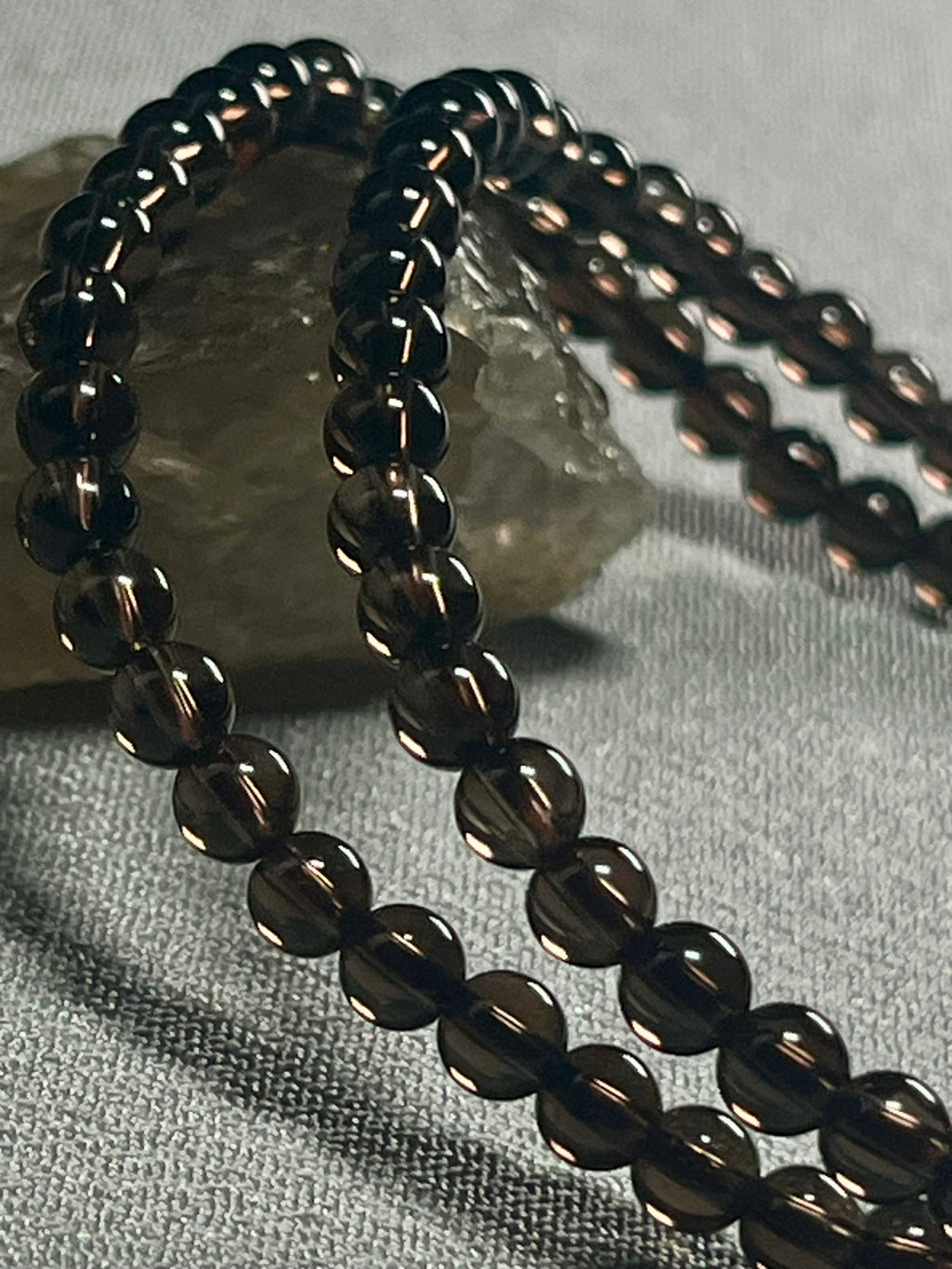 Smoky Quartz smooth round 4mm bead stretch bracelet (premium grade)