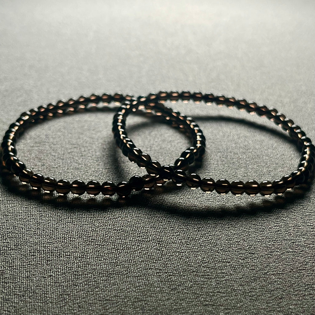 Smoky Quartz smooth round 4mm bead stretch bracelet (premium grade)
