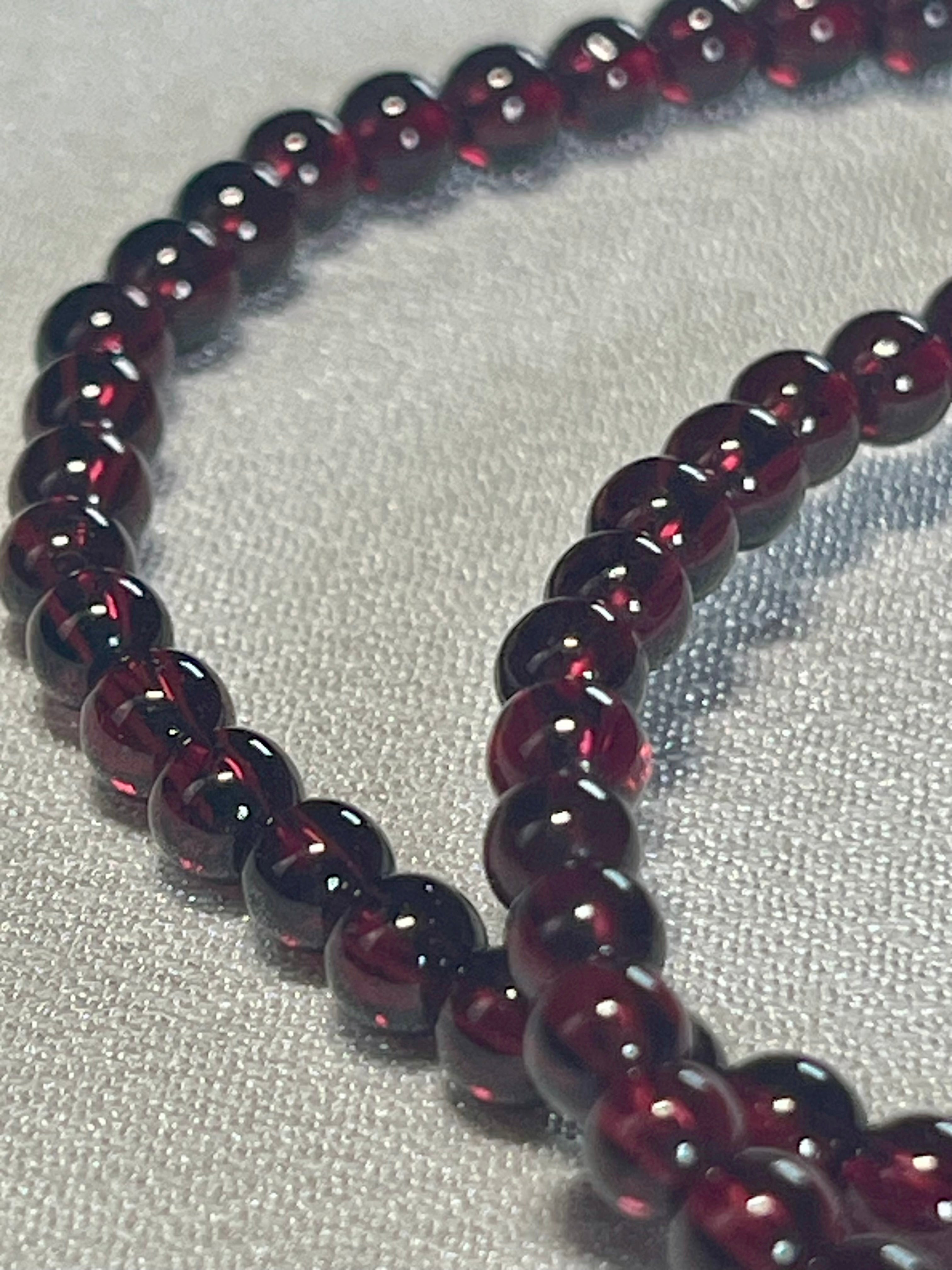 Red Garnet smooth round 4mm stretch bracelet (AA grade); January birthstone