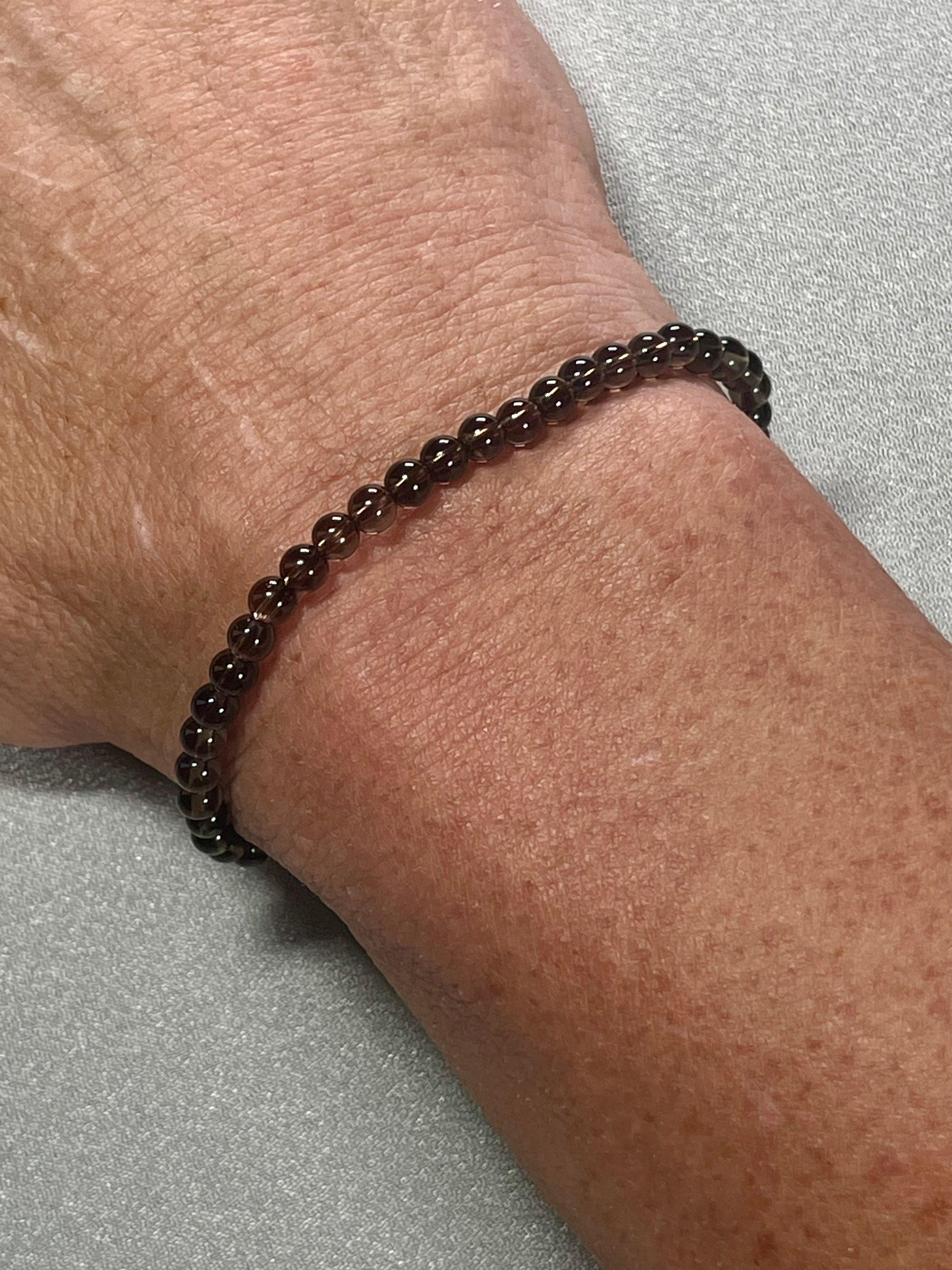 Smoky Quartz smooth round 4mm bead stretch bracelet (premium grade)