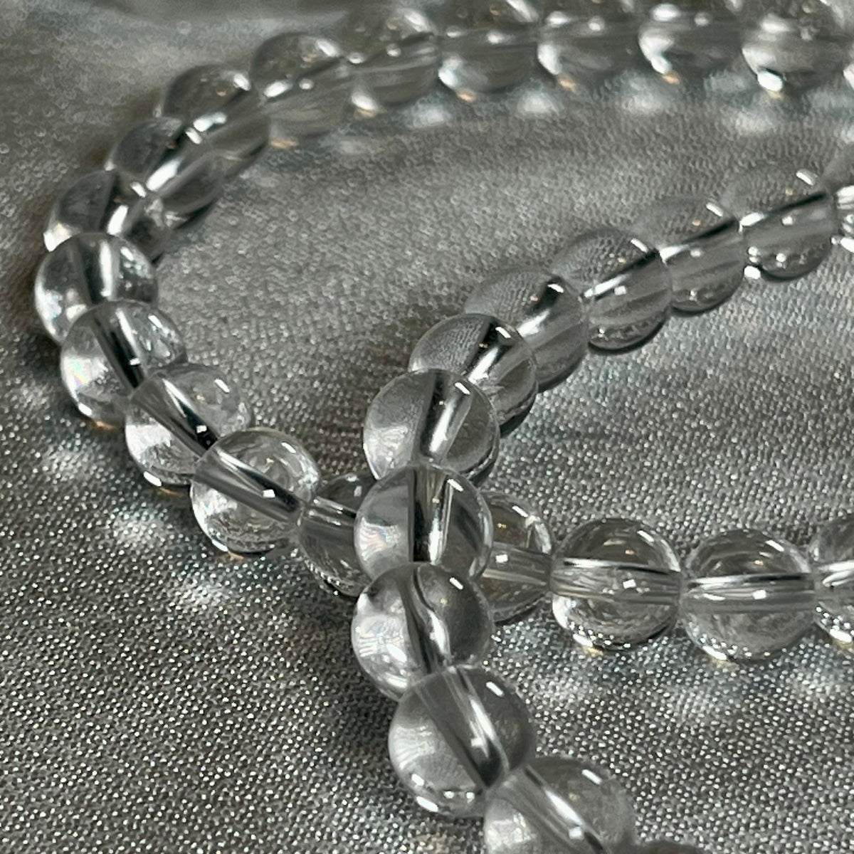 Clear Crystal Quartz smooth round 4mm, 6mm bead stretch bracelet (premium); April birthstone