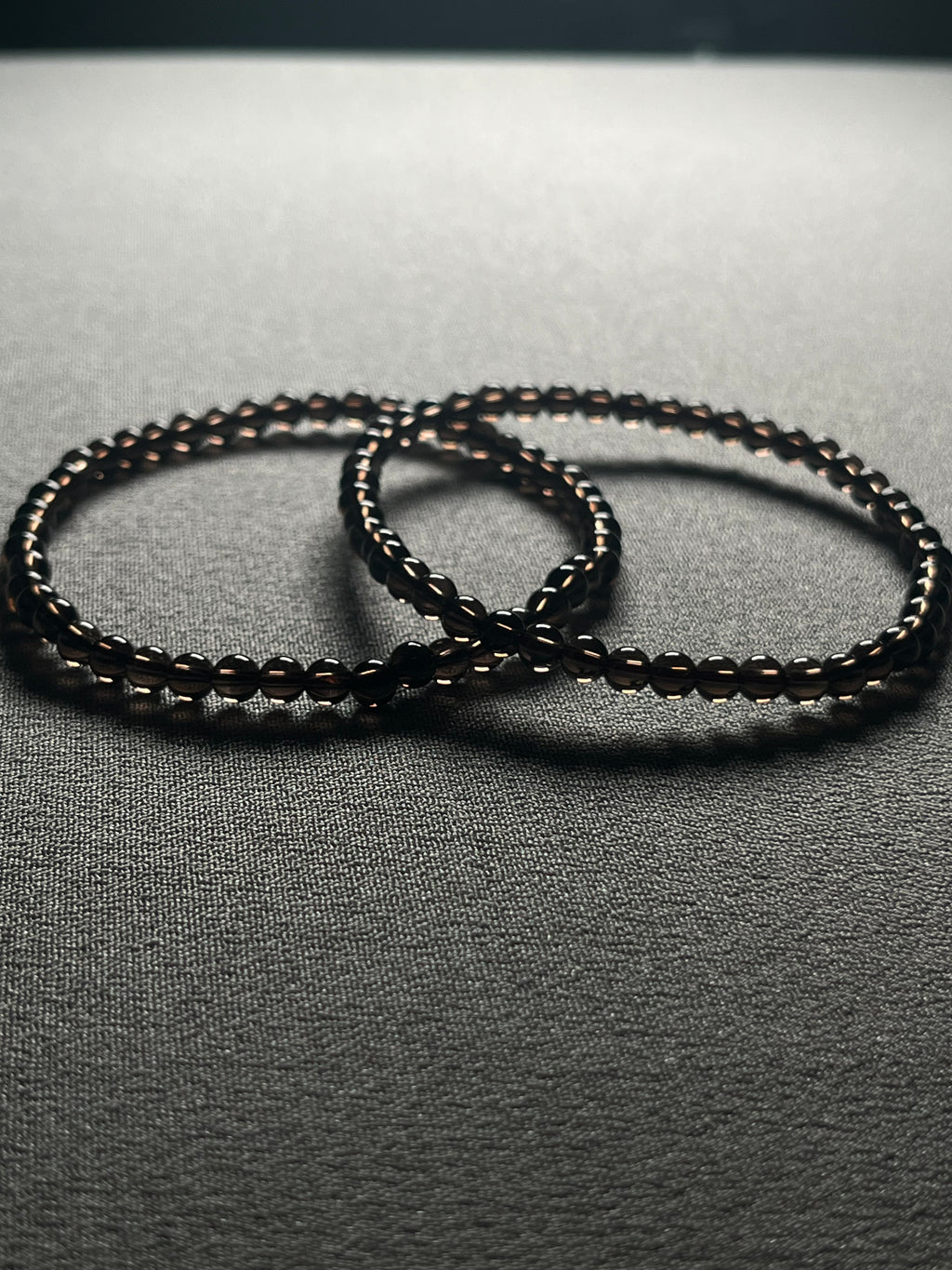 Smoky Quartz smooth round 4mm bead stretch bracelet (premium grade)