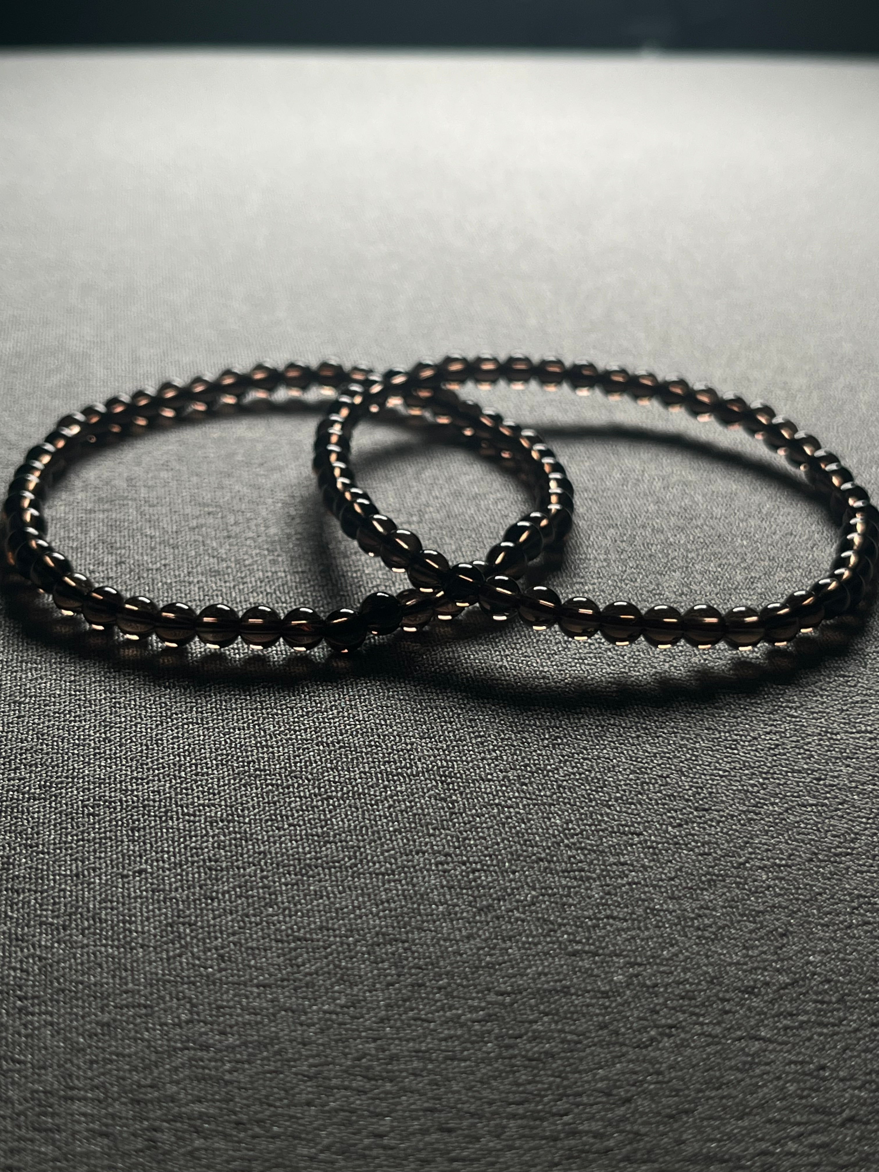 Smoky Quartz smooth round 4mm bead stretch bracelet (premium grade)