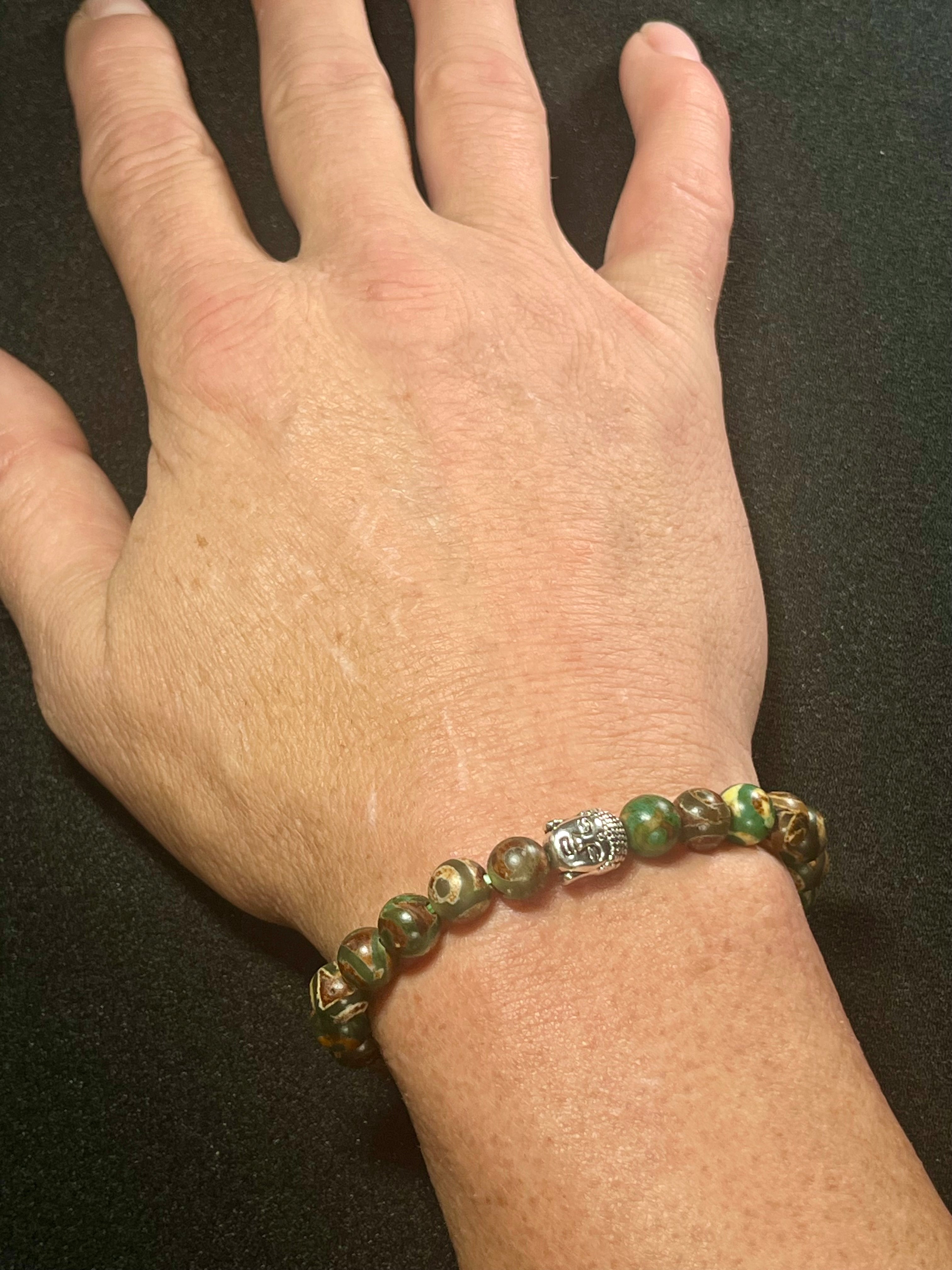 Tibetan Green Eye Agate (dzi) Matte smooth round 8mm bead stretch bracelet w/ silver Buddha accent bead.