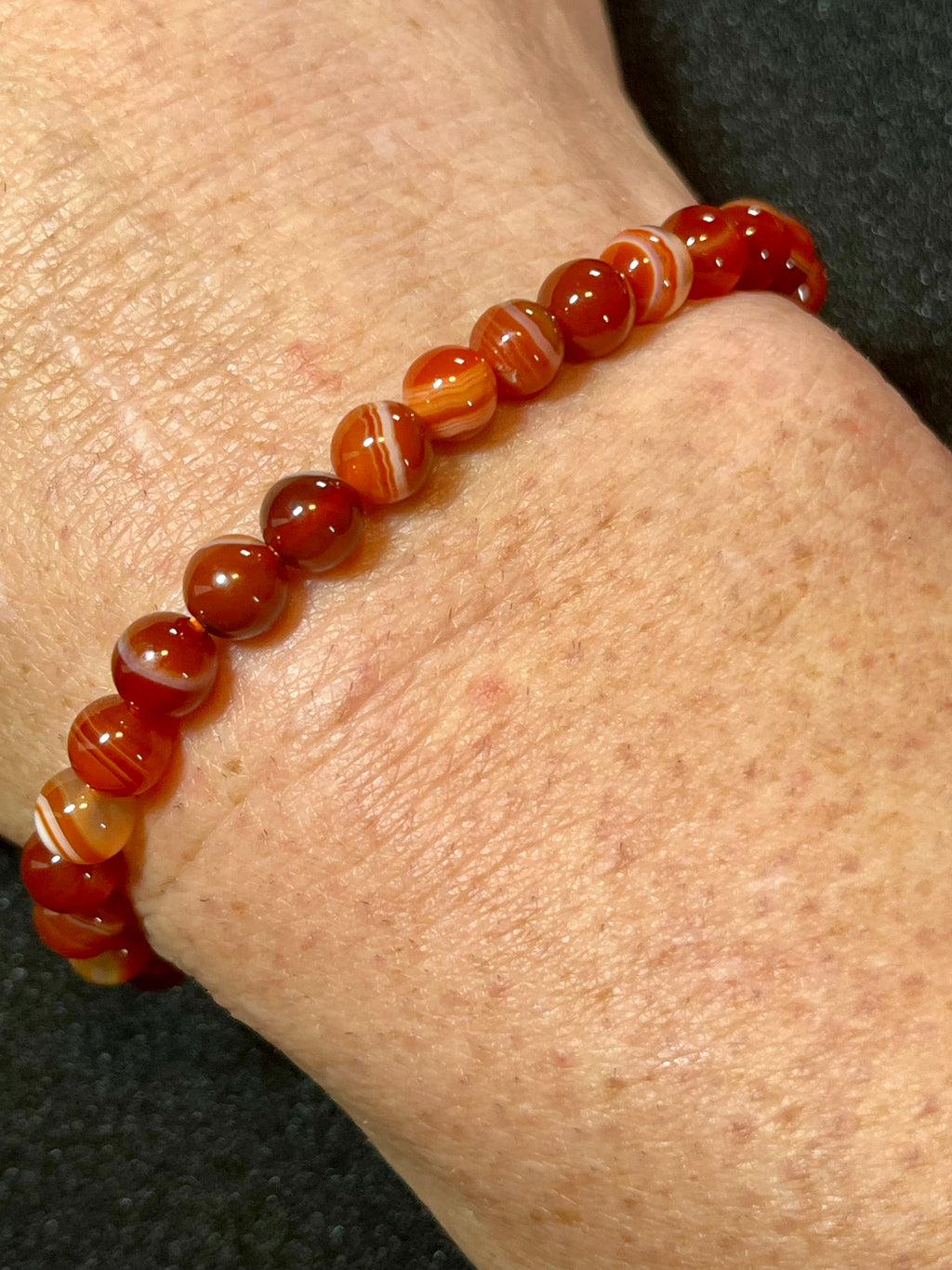 Carnelian (dark orange) smooth round 6mm bead stretch bracelet; July birthstone