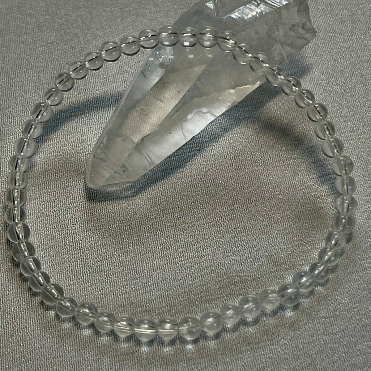 Clear Crystal Quartz smooth round 4mm, 6mm bead stretch bracelet (premium); April birthstone