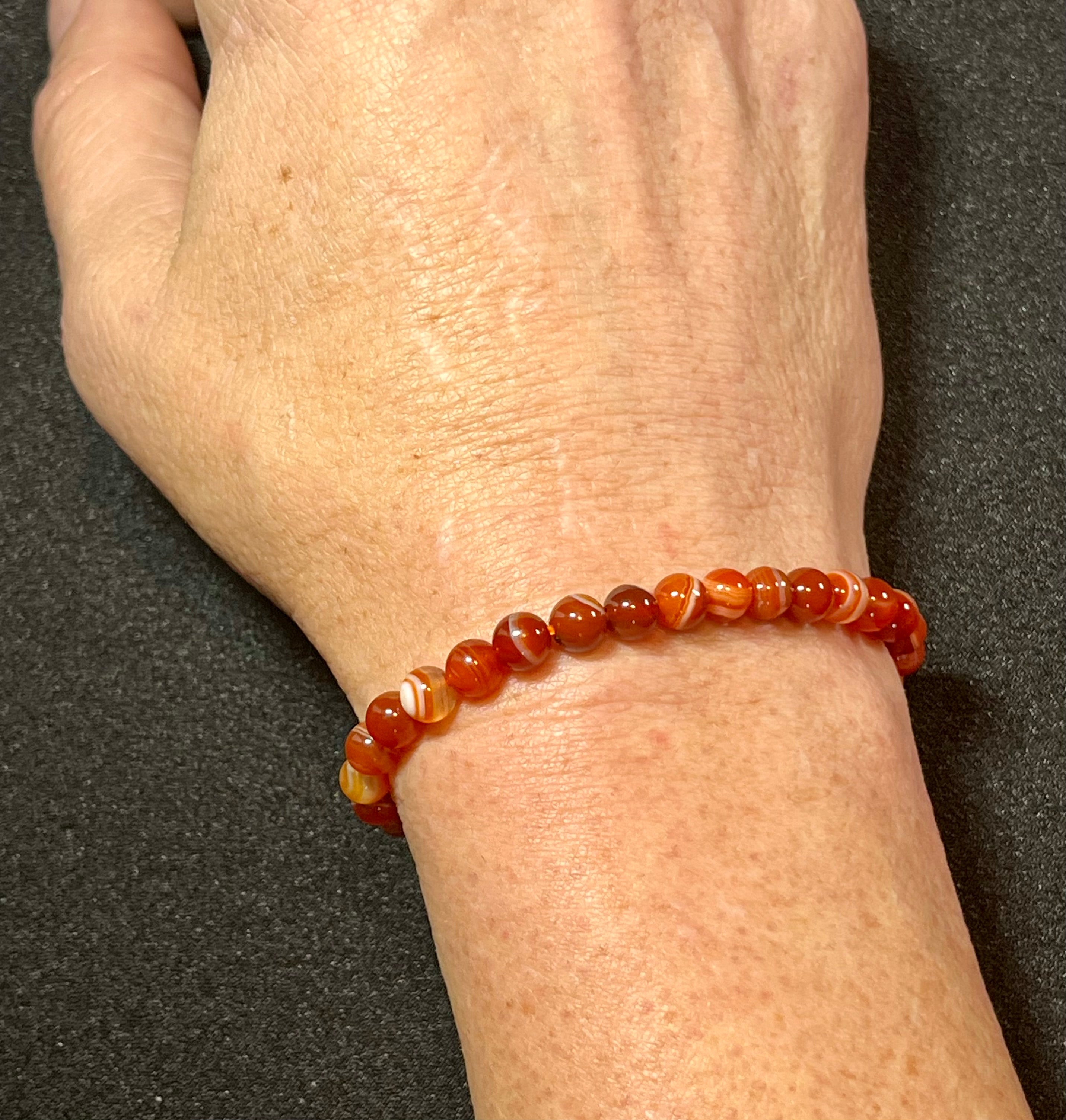 Carnelian (dark orange) smooth round 6mm bead stretch bracelet; July birthstone