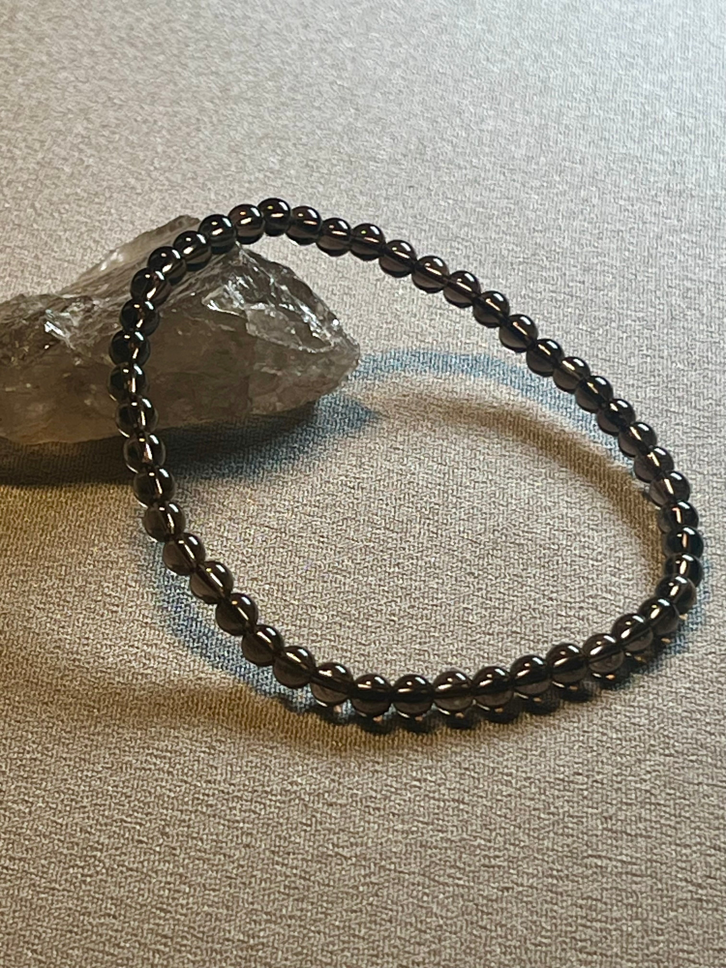 Smoky Quartz smooth round 4mm bead stretch bracelet (premium grade)