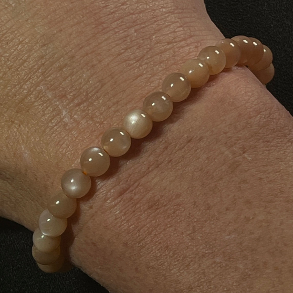 Peach Moonstone (w/ strong flash) smooth round 6mm bead stretch bracelet; June birthstone