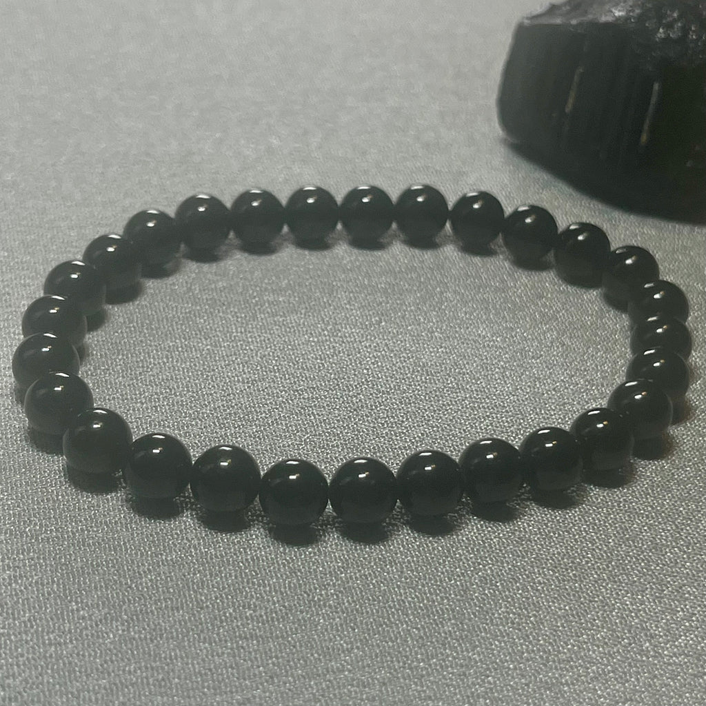 Black Tourmaline (Schorl) smooth round 6mm bead stretch bracelet (premium); October birthstone
