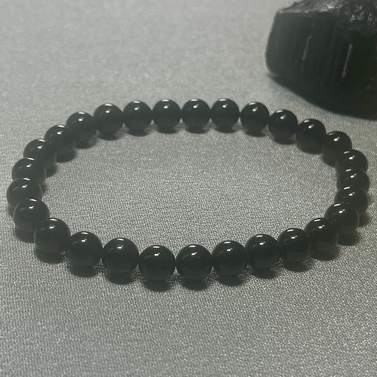Black Tourmaline (Schorl) smooth round 6mm bead stretch bracelet (premium); October birthstone