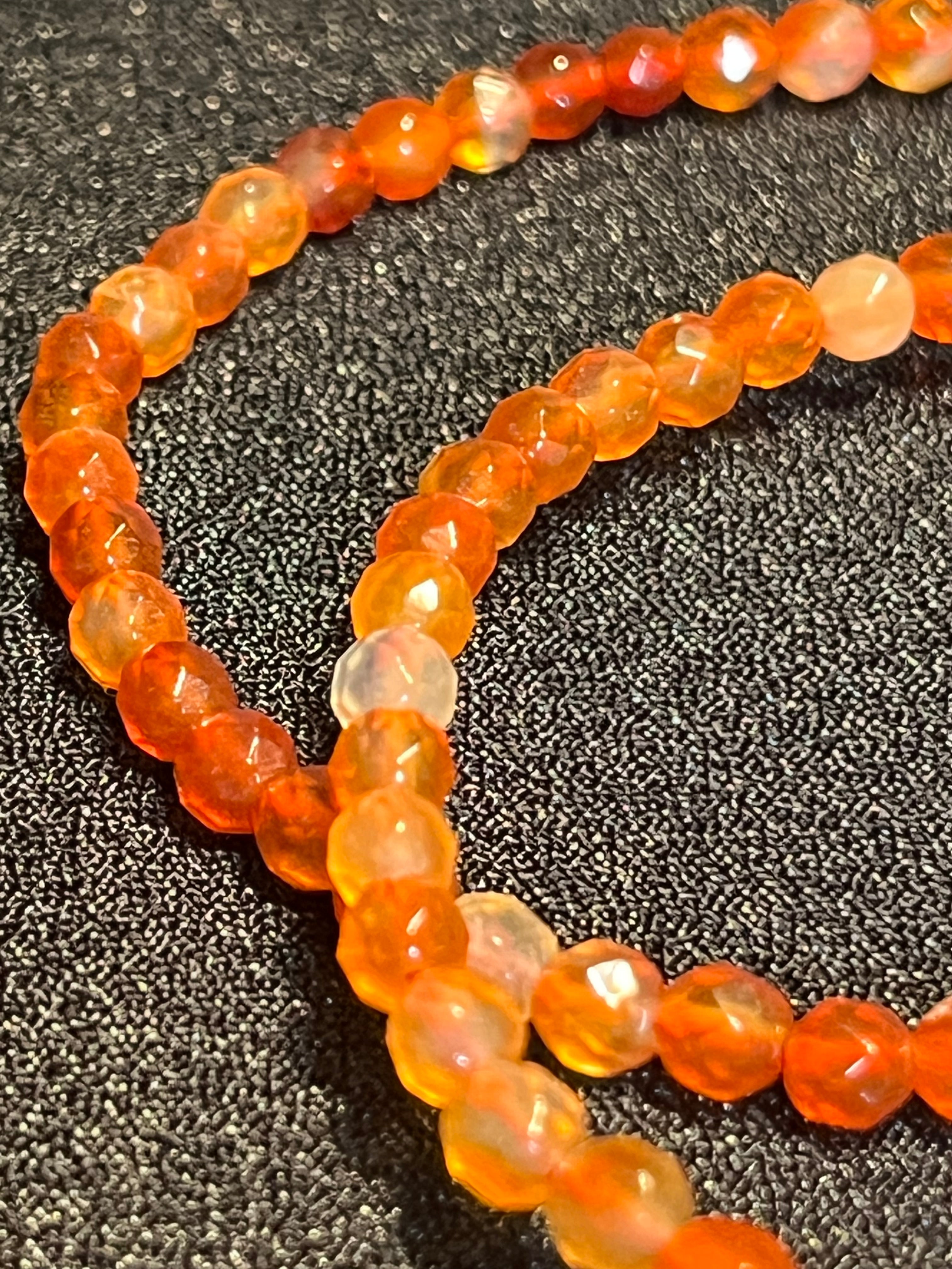 Carnelian (multi-orange) faceted round 4mm bead stretch bracelet; July birthstone