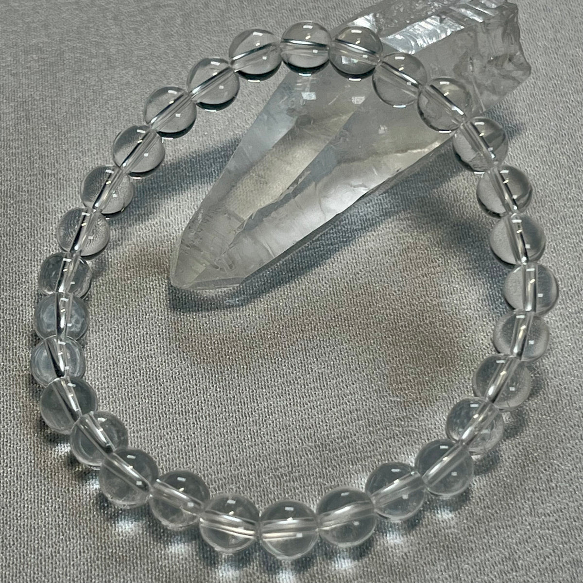 Clear Crystal Quartz smooth round 4mm, 6mm bead stretch bracelet (premium); April birthstone