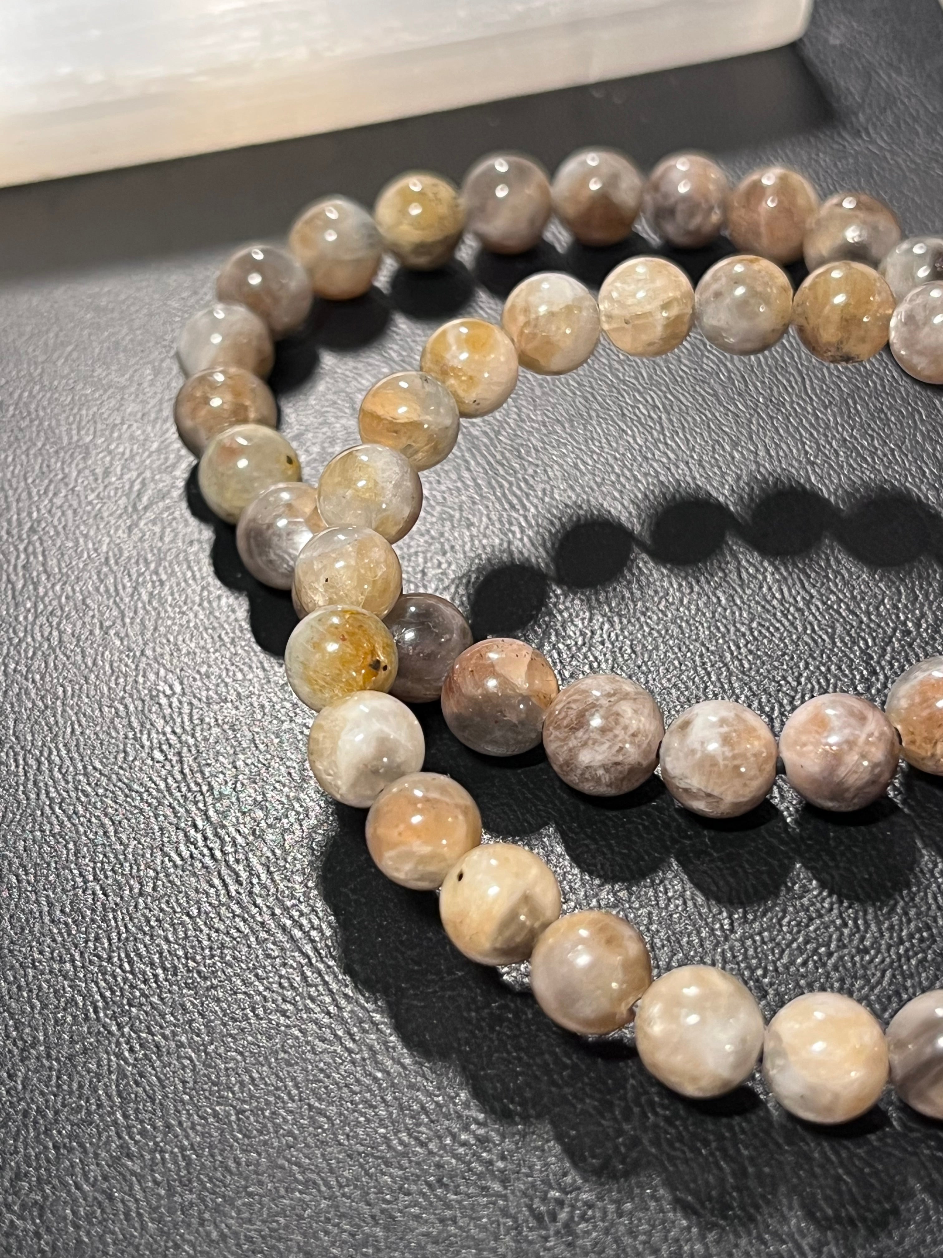 Black Sunstone smooth round 7mm bead stretch bracelet (AA grade)