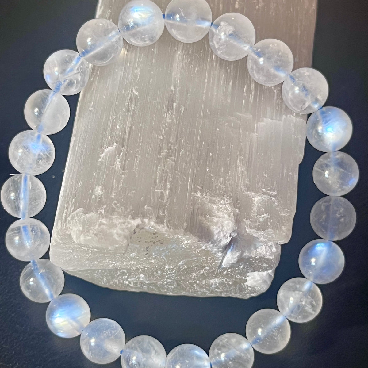 Blue Moonstone smooth round 8mm high-clarity blue flash bead stretch bracelet; June birthstone