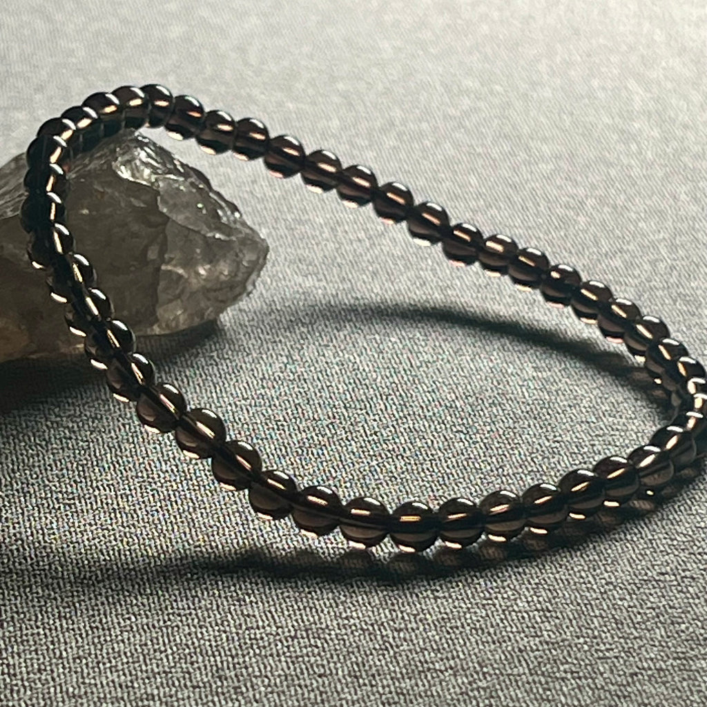 Smoky Quartz smooth round 4mm bead stretch bracelet (premium grade)