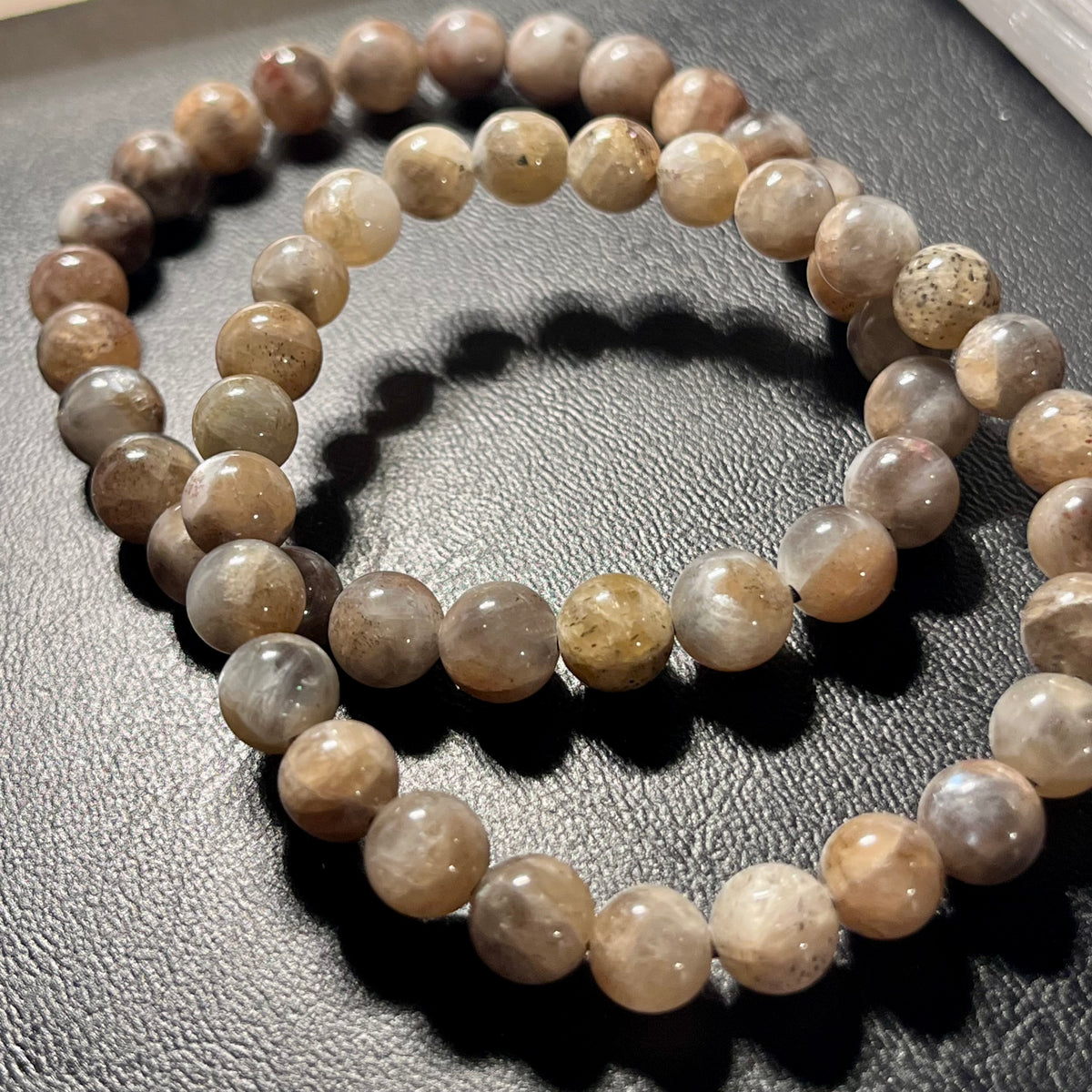 Black Sunstone smooth round 7mm bead stretch bracelet (AA grade)