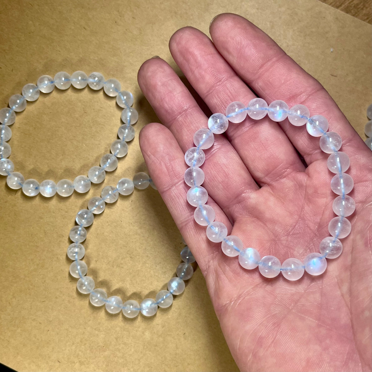Blue Moonstone smooth round 8mm high-clarity blue flash bead stretch bracelet; June birthstone