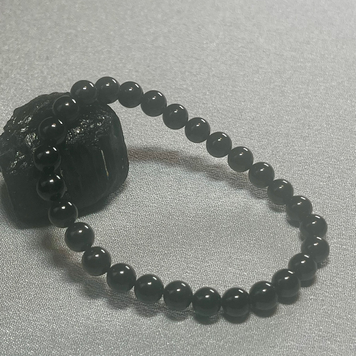Black Tourmaline (Schorl) smooth round 6mm bead stretch bracelet (premium); October birthstone