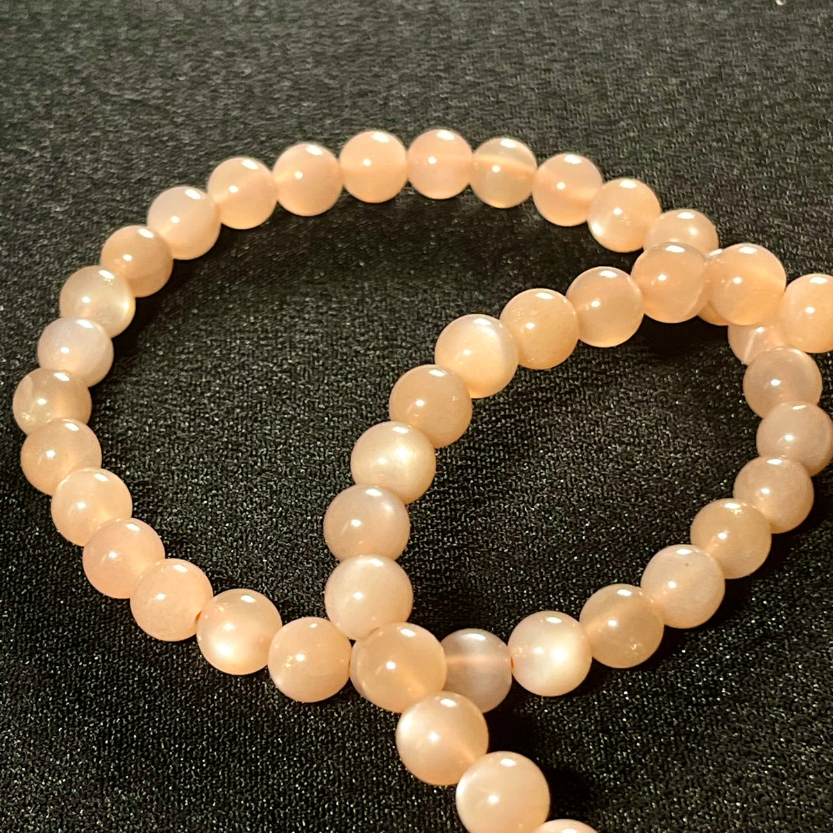 Peach Moonstone (w/ strong flash) smooth round 6mm bead stretch bracelet; June birthstone