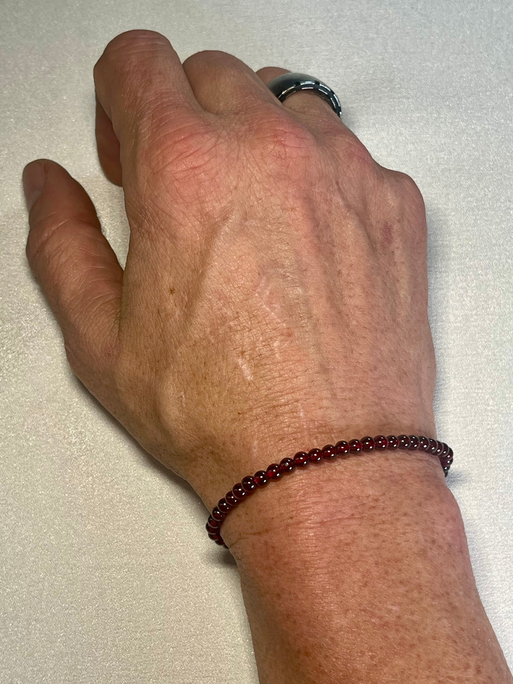 Red Garnet smooth round 4mm stretch bracelet (AA grade); January birthstone
