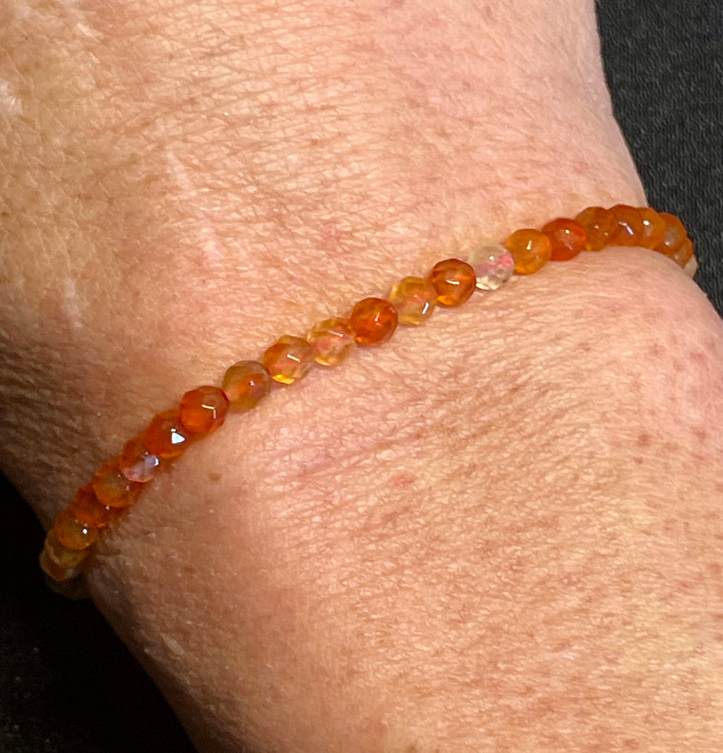 Carnelian (multi-orange) faceted round 4mm bead stretch bracelet; July birthstone