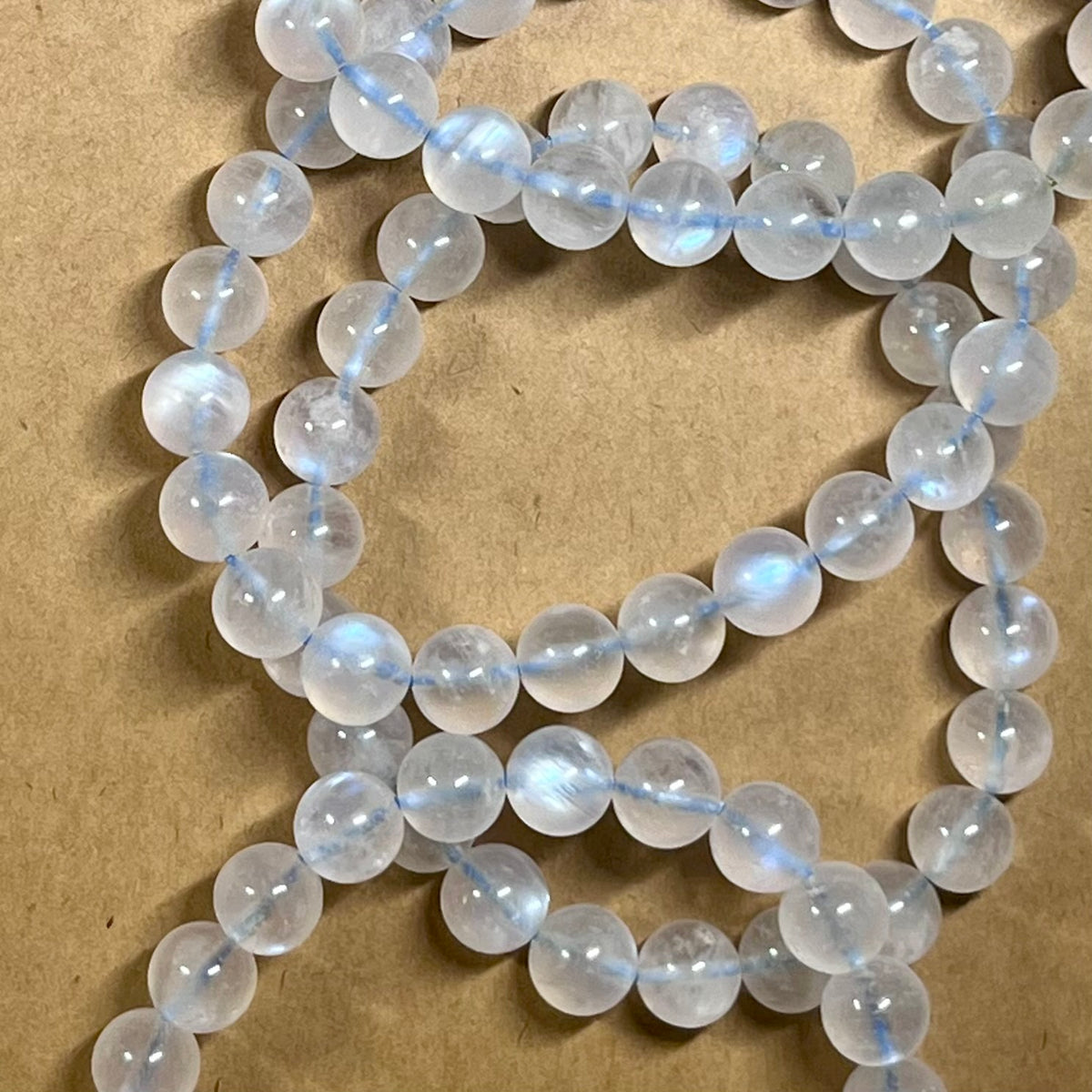 Blue Moonstone smooth round 8mm high-clarity blue flash bead stretch bracelet; June birthstone