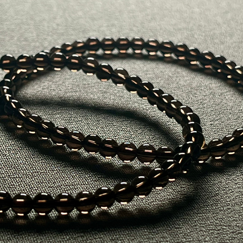 Smoky Quartz smooth round 4mm bead stretch bracelet (premium grade)