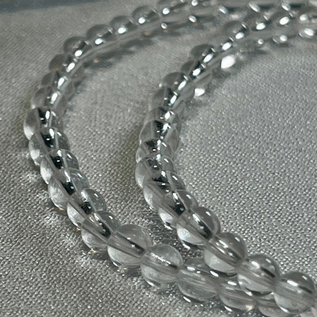 Clear Crystal Quartz smooth round 4mm, 6mm bead stretch bracelet (premium); April birthstone