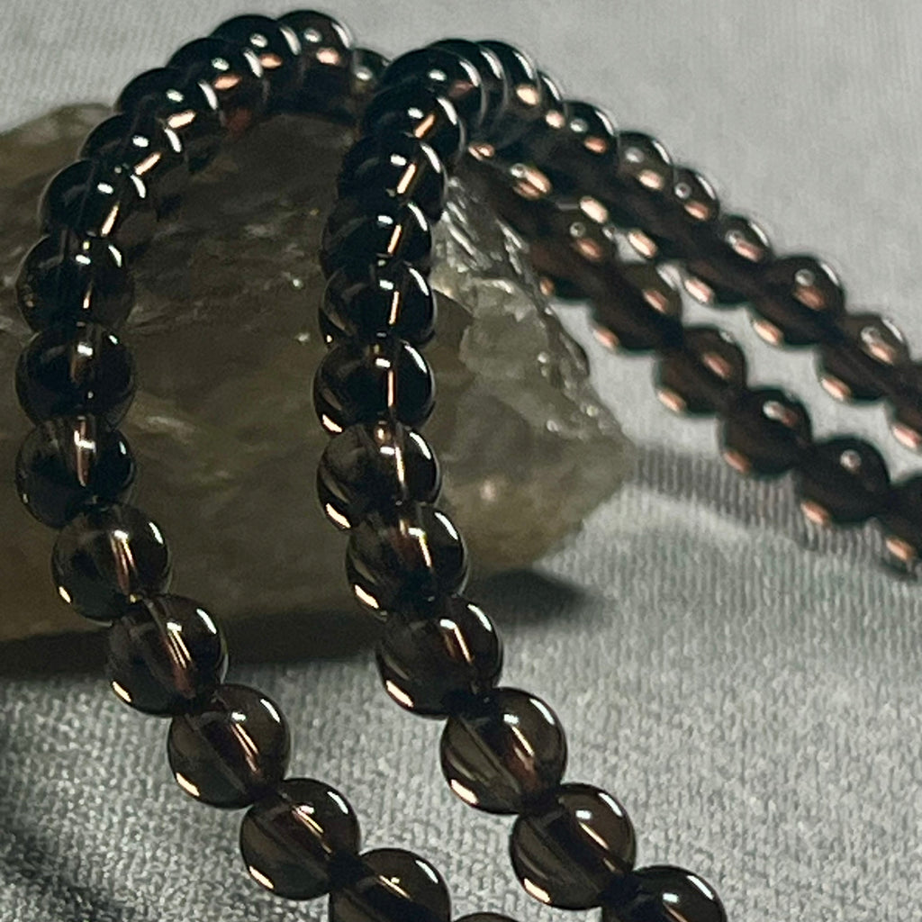 Smoky Quartz smooth round 4mm bead stretch bracelet (premium grade)
