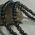 Smoky Quartz smooth round 4mm bead stretch bracelet (premium grade)