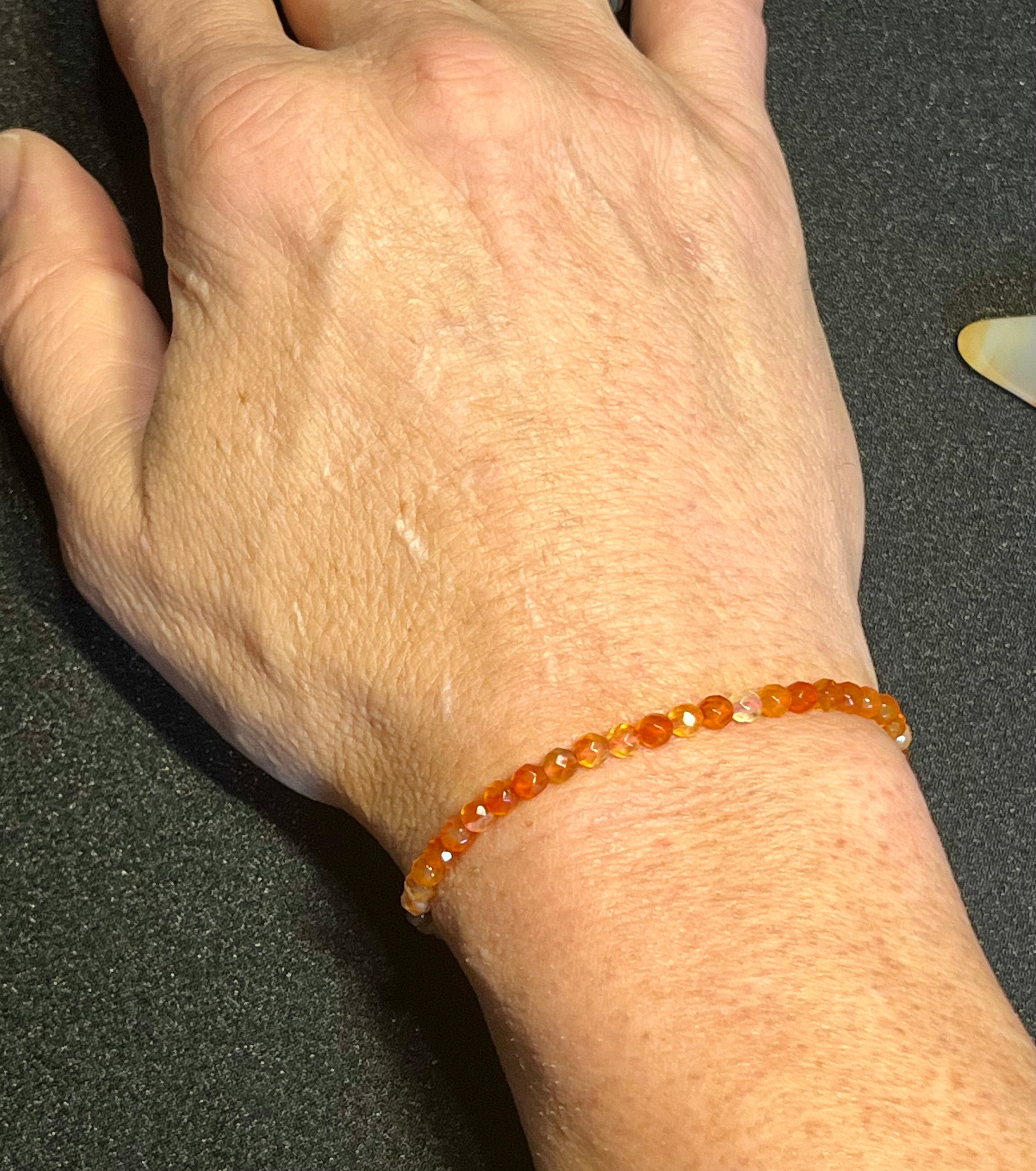 Carnelian (multi-orange) faceted round 4mm bead stretch bracelet; July birthstone