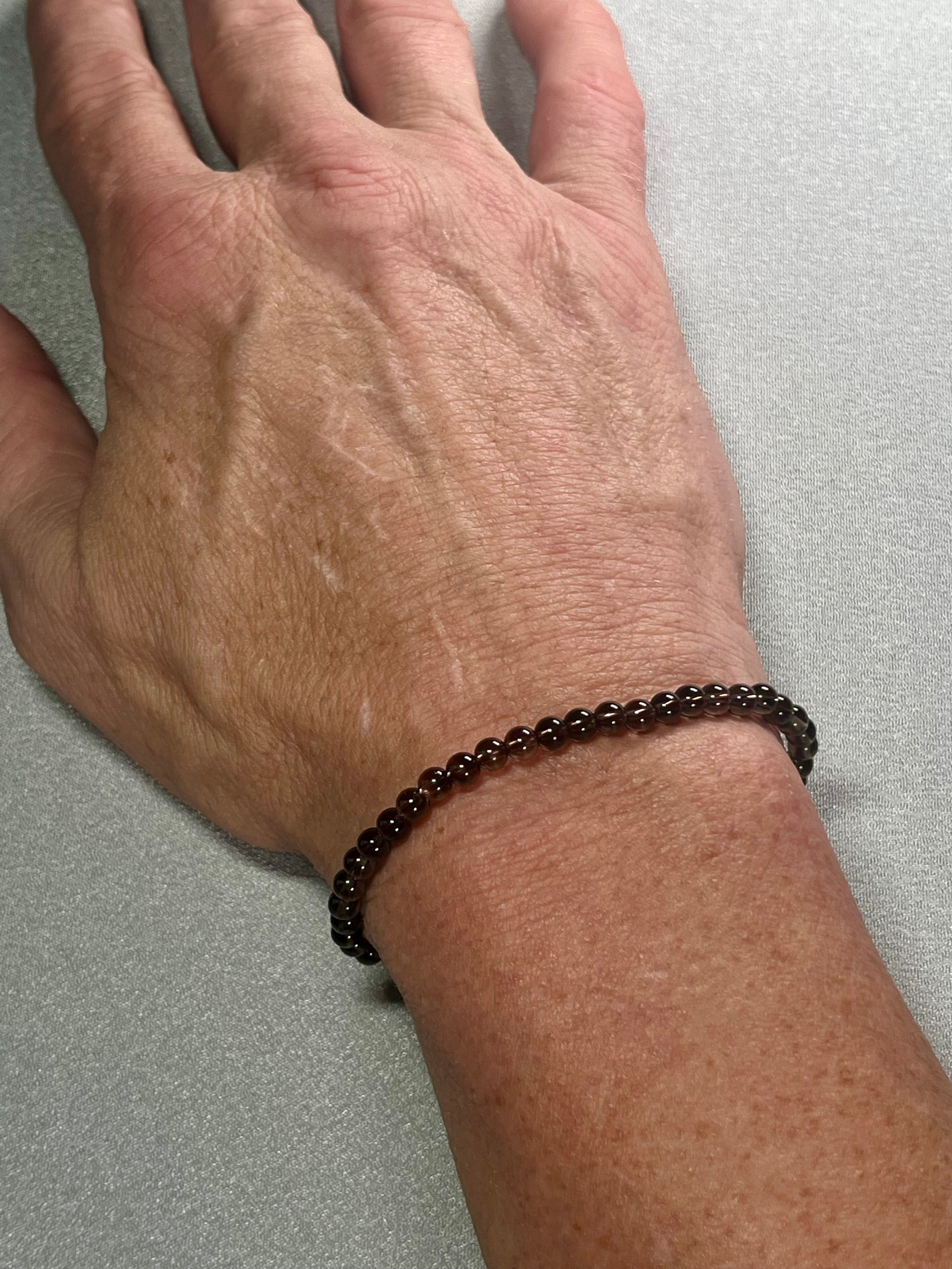 Smoky Quartz smooth round 4mm bead stretch bracelet (premium grade)